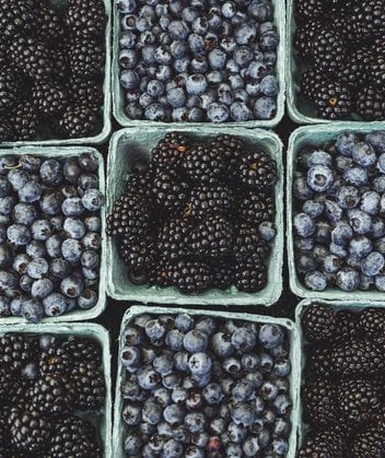 black berries on black surface