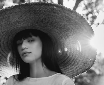 woman in white crew neck shirt wearing brown sun hat