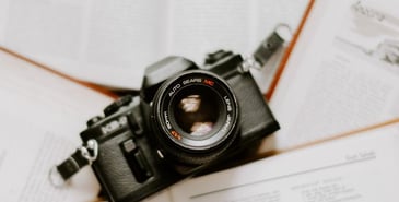 black nikon dslr camera on white printer paper