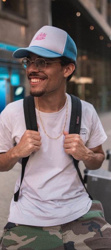 man in white crew neck t-shirt wearing blue cap and black sunglasses