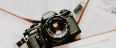 black nikon dslr camera on white printer paper