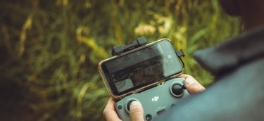 person holding black and gray digital camera