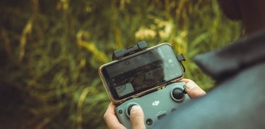 person holding black and gray digital camera