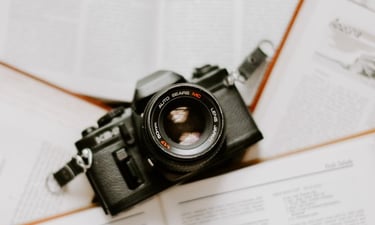 black nikon dslr camera on white printer paper