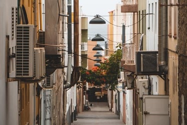 empty hallway between concrete buildings during daytime