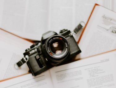 black nikon dslr camera on white printer paper