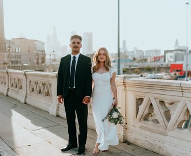 man in black suit standing beside woman in white wedding dress