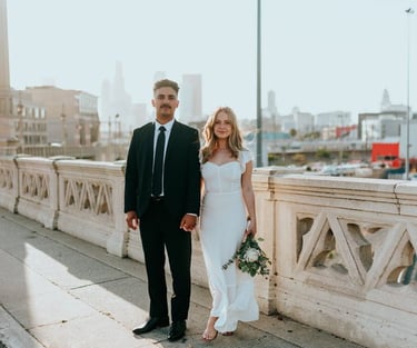 man in black suit standing beside woman in white wedding dress