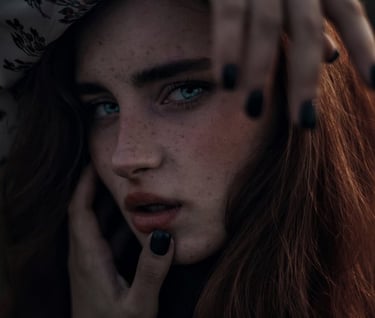woman with brown hair wearing white and black floral hijab