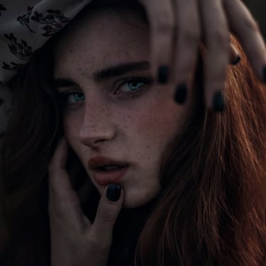woman with brown hair wearing white and black floral hijab