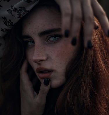 woman with brown hair wearing white and black floral hijab