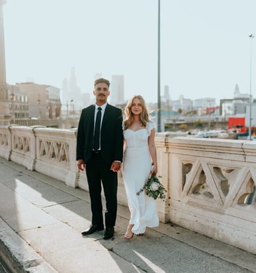 man in black suit standing beside woman in white wedding dress