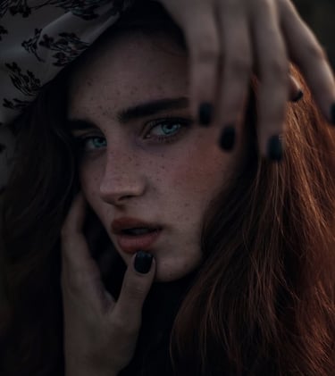 woman with brown hair wearing white and black floral hijab