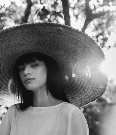 woman in white crew neck shirt wearing brown sun hat
