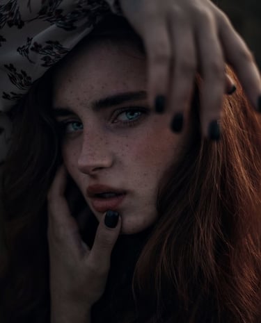woman with brown hair wearing white and black floral hijab