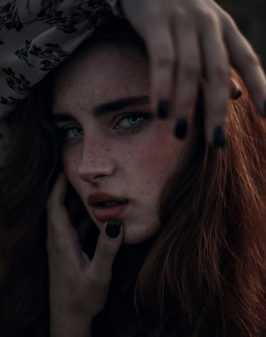 woman with brown hair wearing white and black floral hijab
