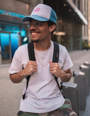 man in white crew neck t-shirt wearing blue cap and black sunglasses