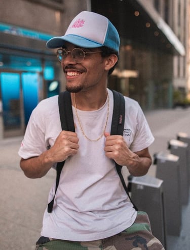 man in white crew neck t-shirt wearing blue cap and black sunglasses