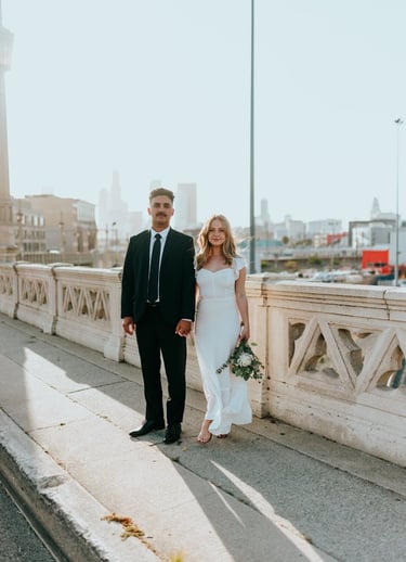 man in black suit standing beside woman in white wedding dress