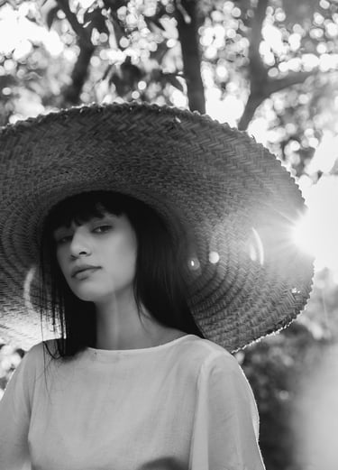 woman in white crew neck shirt wearing brown sun hat