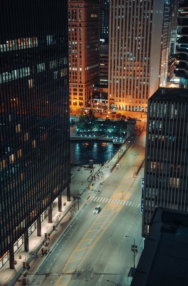 body of water between high rise buildings during night time