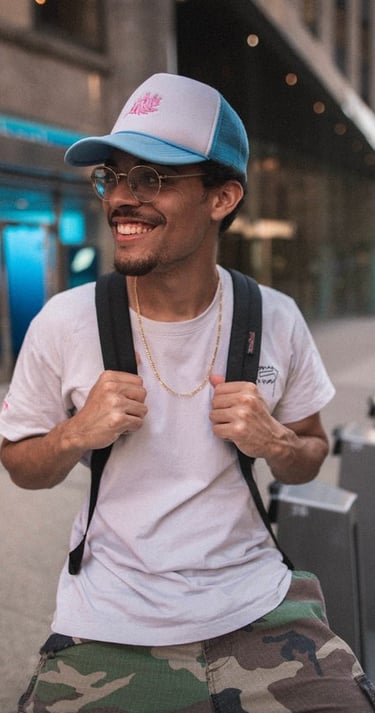man in white crew neck t-shirt wearing blue cap and black sunglasses