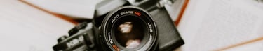 black nikon dslr camera on white printer paper