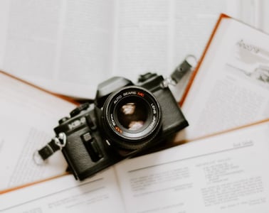 black nikon dslr camera on white printer paper
