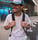 man in white crew neck t-shirt wearing blue cap and black sunglasses