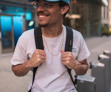 man in white crew neck t-shirt wearing blue cap and black sunglasses