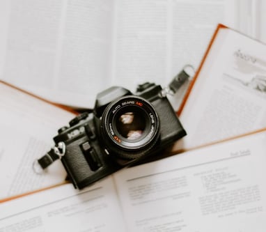 black nikon dslr camera on white printer paper