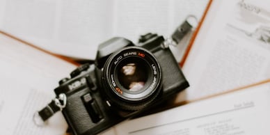 black nikon dslr camera on white printer paper