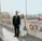 man in black suit standing beside woman in white wedding dress