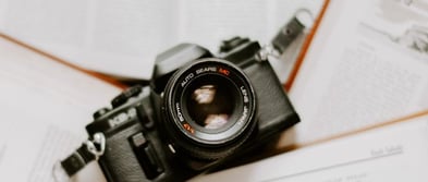 black nikon dslr camera on white printer paper