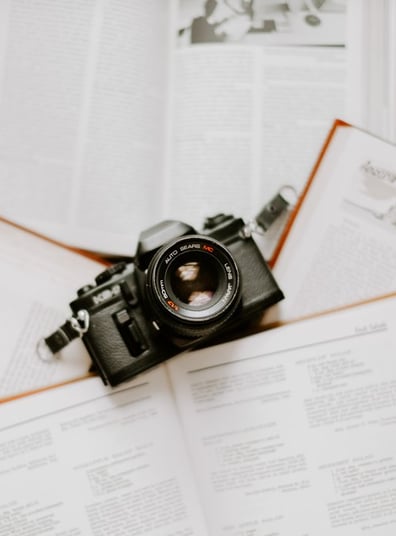 black nikon dslr camera on white printer paper