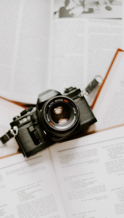 black nikon dslr camera on white printer paper