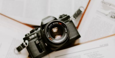 black nikon dslr camera on white printer paper