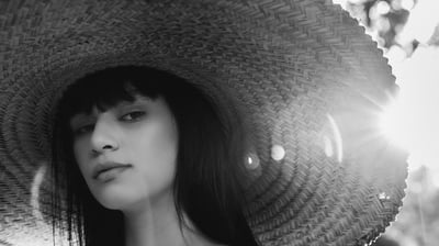woman in white crew neck shirt wearing brown sun hat