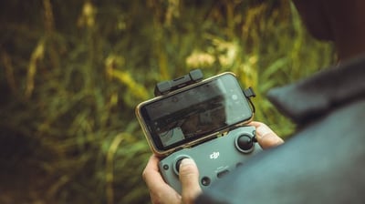 person holding black and gray digital camera