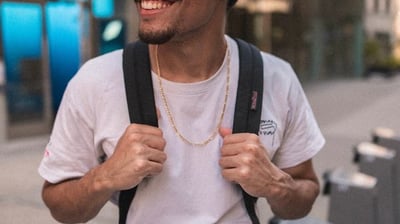 man in white crew neck t-shirt wearing blue cap and black sunglasses