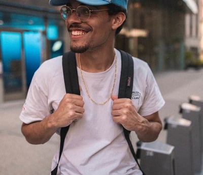 man in white crew neck t-shirt wearing blue cap and black sunglasses