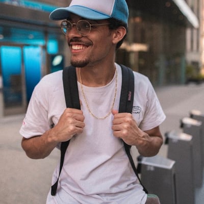 man in white crew neck t-shirt wearing blue cap and black sunglasses