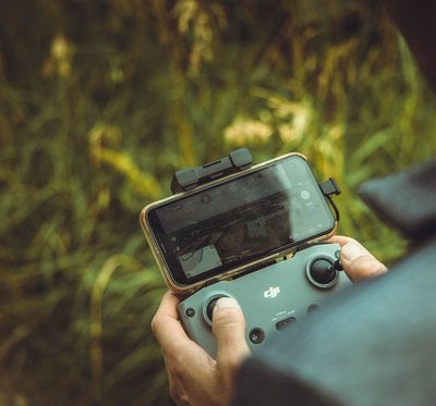 person holding black and gray digital camera