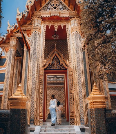 man and woman standing in front of brown concrete building during daytime