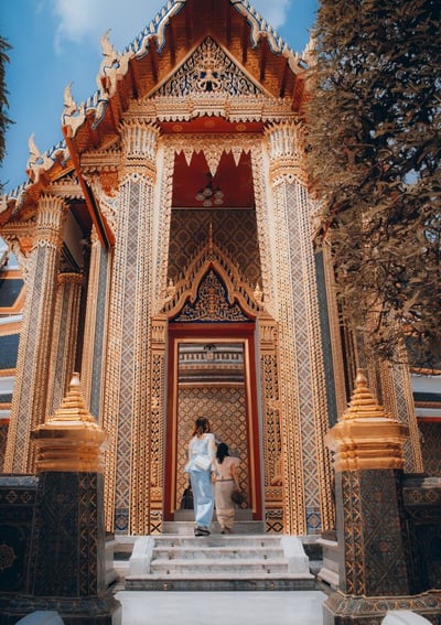 man and woman standing in front of brown concrete building during daytime