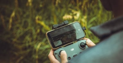 person holding black and gray digital camera