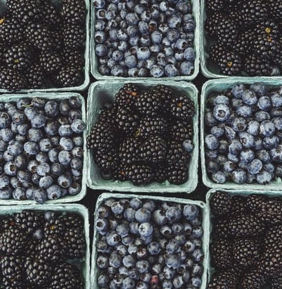 black berries on black surface