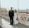 man in black suit standing beside woman in white wedding dress