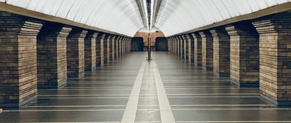 man in black jacket walking on hallway