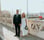 man in black suit standing beside woman in white wedding dress
